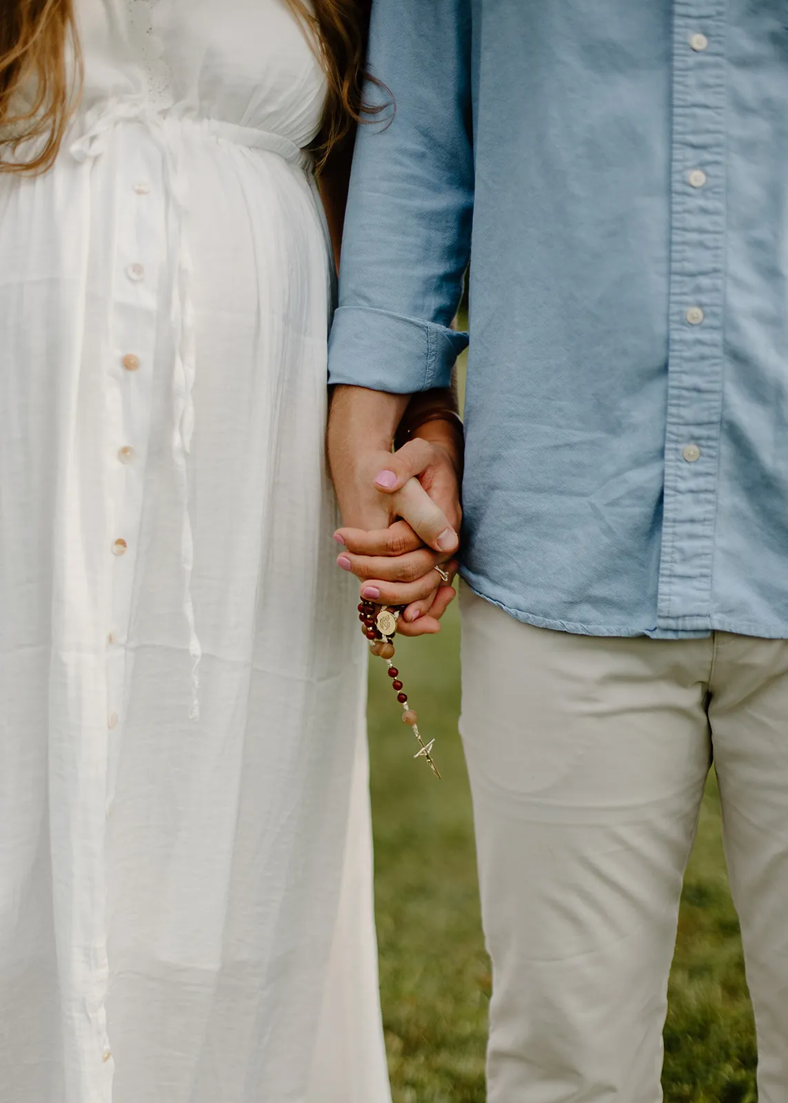 Holding hands with a rosary between them