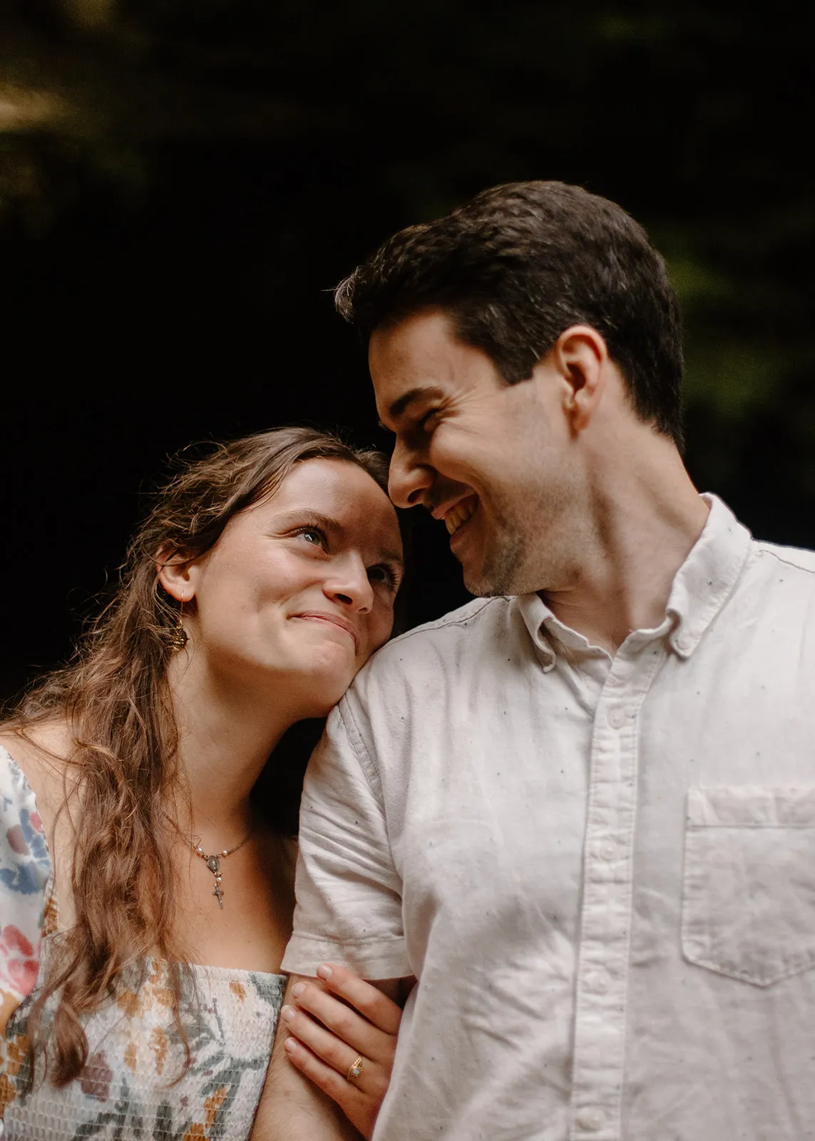 Grace resting her head on John's shoulder, both smiling
