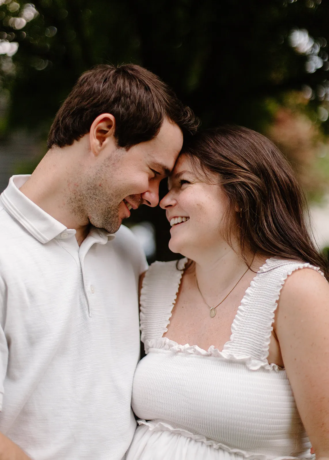 Mom and dad forehead to forehead, laughing